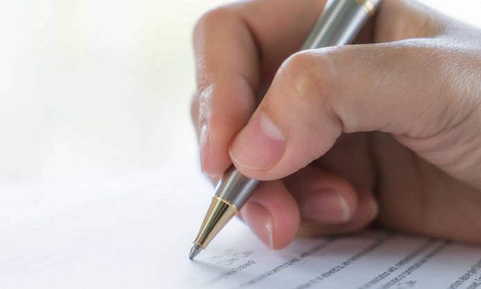 hand-with-pen-application-form-1-scaled